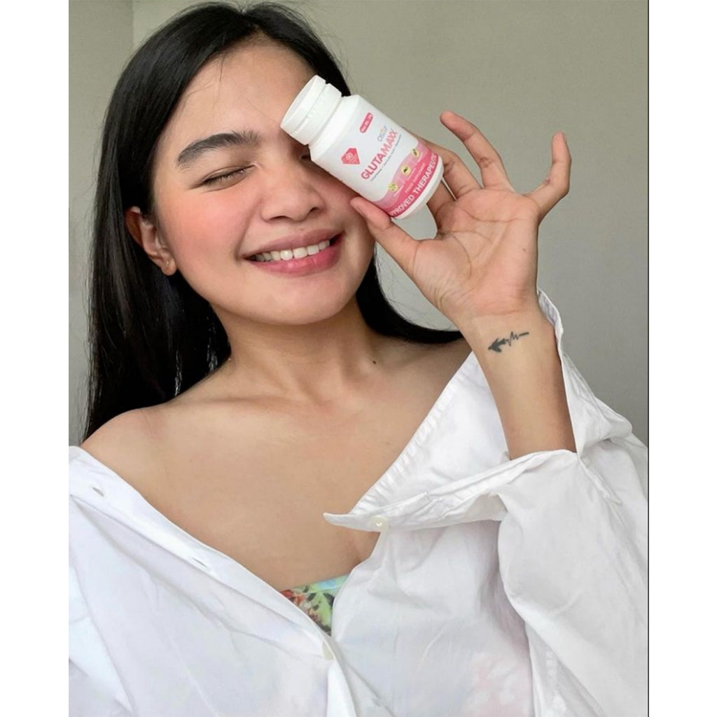Model with radiant skin holding Gluta Maxx bottle